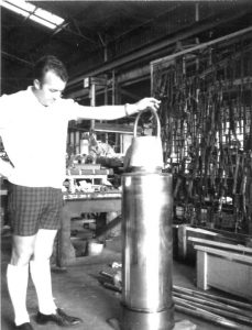 HMG employee holding a chrome plated rod 1961